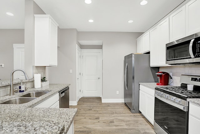 8266 Glacier Ridge Dr, Fishers, IN 46038 - kitchen featuring stainless steel appliances, a sink, light wood finished floors, white cabinetry, and recessed lighting
