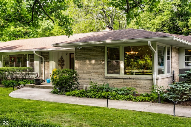 6220 Spring Mill Rd, Indianapolis, IN 46260 - single story home with roof with shingles, a front lawn, stone siding, and a chimney