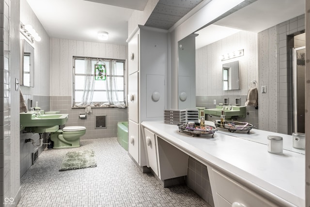 6220 Spring Mill Rd, Indianapolis, IN 46260 - bathroom with wallpapered walls, tile walls, wainscoting, and toilet
