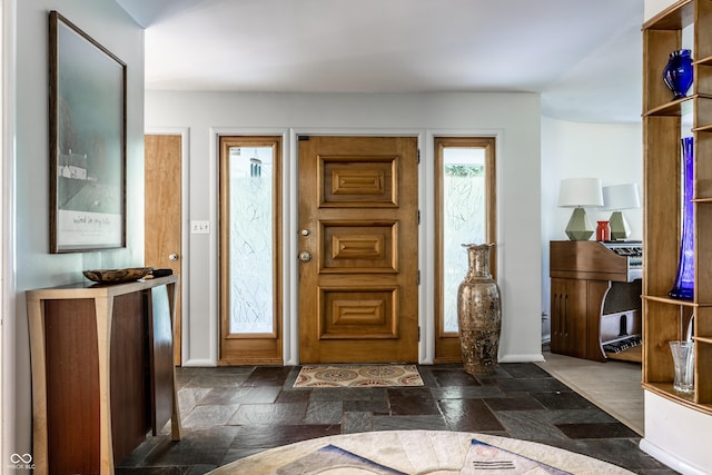 6220 Spring Mill Rd, Indianapolis, IN 46260 - foyer entrance with stone tile floors and baseboards