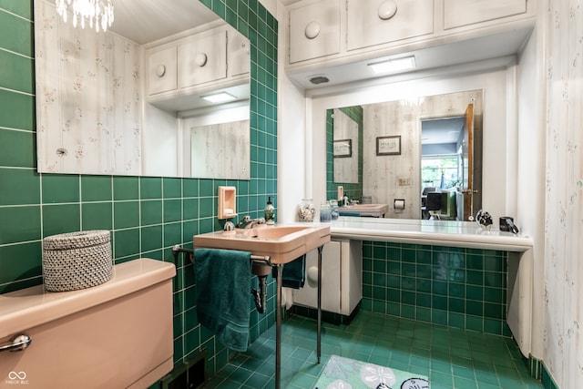 6220 Spring Mill Rd, Indianapolis, IN 46260 - bathroom with tile patterned floors, tile walls, wallpapered walls, and a sink