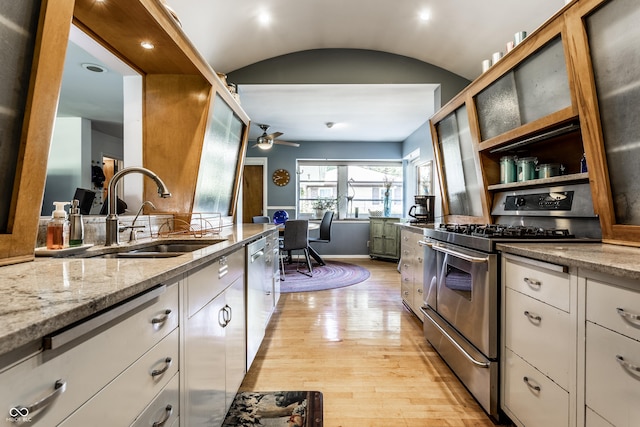 6220 Spring Mill Rd, Indianapolis, IN 46260 - kitchen with stainless steel appliances, a sink, light wood-style floors, ceiling fan, and light stone counters