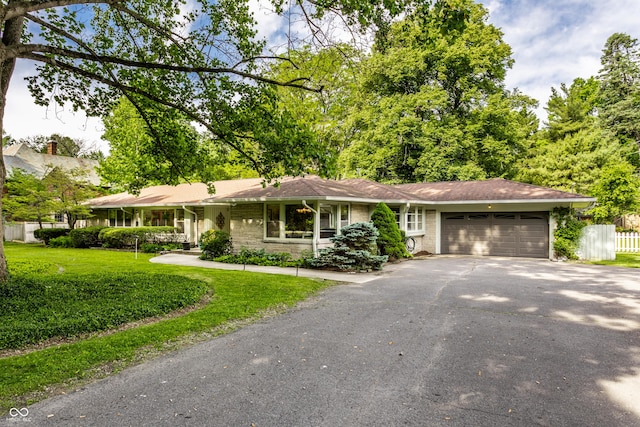 6220 Spring Mill Rd, Indianapolis, IN 46260 - ranch-style home with driveway, a garage, and stone siding