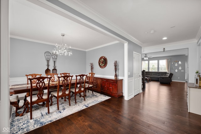 15580 Garrano Ln, Fishers, IN 46040 - dining room featuring dark wood-style flooring, crown molding, a chandelier, recessed lighting, and wainscoting