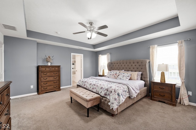 15580 Garrano Ln, Fishers, IN 46040 - bedroom featuring a raised ceiling, light carpet, baseboards, and connected bathroom