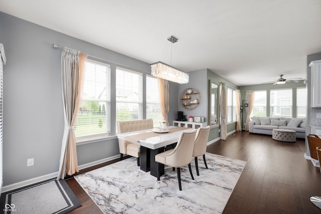 15580 Garrano Ln, Fishers, IN 46040 - dining area with a chandelier, dark wood-style floors, baseboards, and ceiling fan