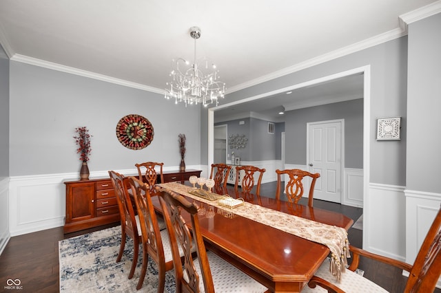 15580 Garrano Ln, Fishers, IN 46040 - dining area featuring wainscoting, a chandelier, ornamental molding, dark wood-style flooring, and a decorative wall
