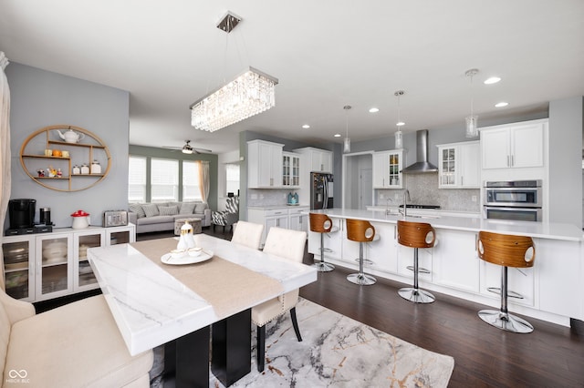 15580 Garrano Ln, Fishers, IN 46040 - dining space featuring dark wood-style floors, recessed lighting, ceiling fan, and a chandelier