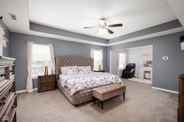 15580 Garrano Ln, Fishers, IN 46040 - bedroom with a raised ceiling, light colored carpet, baseboards, and a ceiling fan