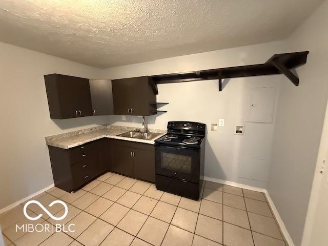 7842 Brennan Rd, Indianapolis, IN 46219 - kitchen featuring black range with electric stovetop, open shelves, a textured ceiling, light tile patterned floors, and light countertops