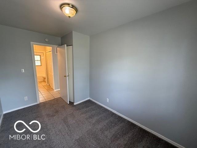 7842 Brennan Rd, Indianapolis, IN 46219 - unfurnished bedroom with carpet and baseboards