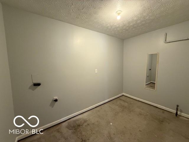 7842 Brennan Rd, Indianapolis, IN 46219 - unfurnished room with carpet floors, a textured ceiling, and baseboards