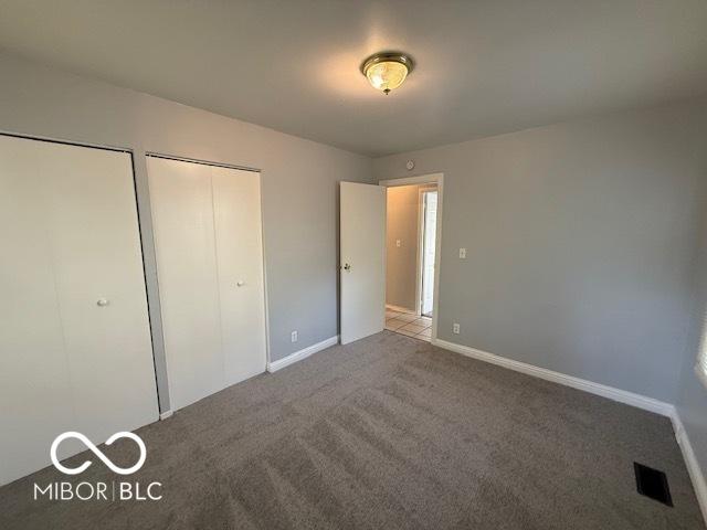 7842 Brennan Rd, Indianapolis, IN 46219 - unfurnished bedroom featuring carpet flooring and baseboards
