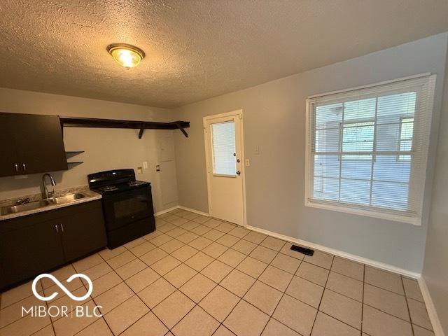 7842 Brennan Rd, Indianapolis, IN 46219 - kitchen featuring black range with electric stovetop, a sink, open shelves, light tile patterned flooring, and a textured ceiling