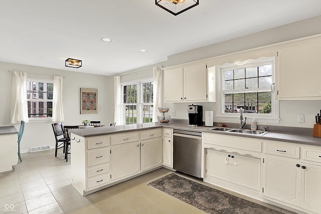 6605 Grosvenor Pl, Indianapolis, IN 46220 - kitchen featuring stainless steel dishwasher, a sink, a peninsula, plenty of natural light, and recessed lighting
