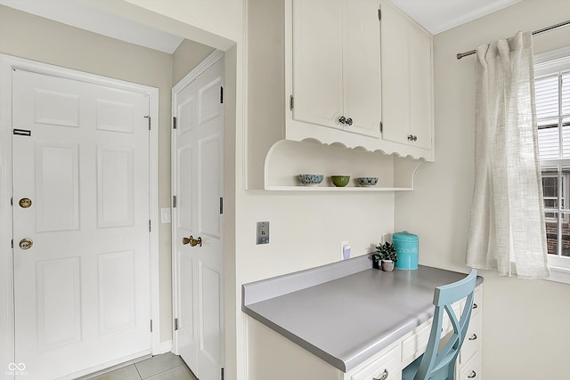 6605 Grosvenor Pl, Indianapolis, IN 46220 - kitchen featuring white cabinets, an office area, open shelves, and light tile patterned floors