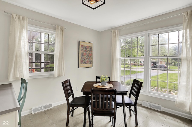 6605 Grosvenor Pl, Indianapolis, IN 46220 - dining area with healthy amount of natural light, baseboards, and light tile patterned flooring