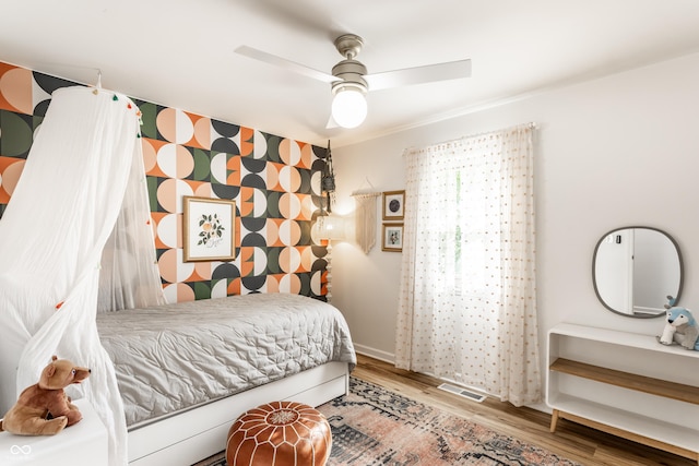 7110 N Layman Ave, Indianapolis, IN 46250 - bedroom with wood finished floors, ceiling fan, and baseboards