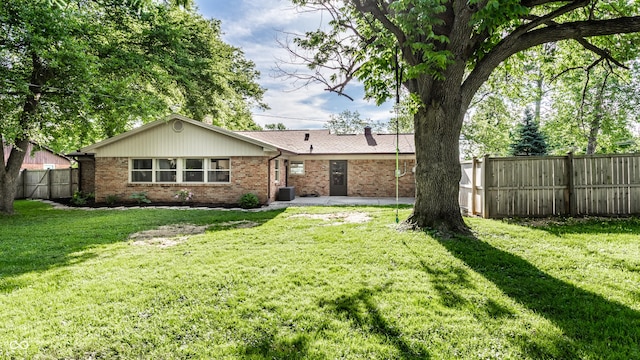 7110 N Layman Ave, Indianapolis, IN 46250 - rear view of property featuring brick siding and a patio area