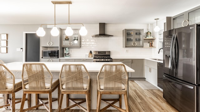 7110 N Layman Ave, Indianapolis, IN 46250 - kitchen featuring appliances with stainless steel finishes, wall chimney exhaust hood, gray cabinetry, and a sink