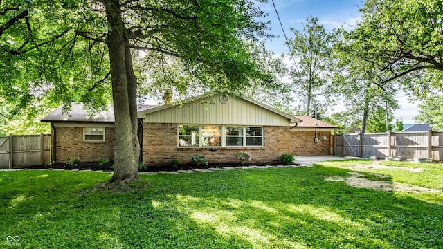 7110 N Layman Ave, Indianapolis, IN 46250 - back of property featuring brick siding and a gate