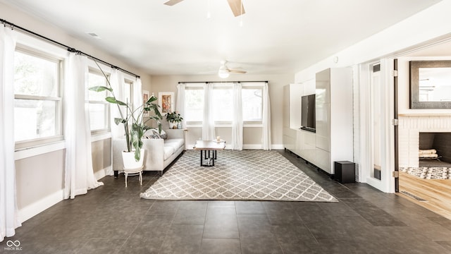 7110 N Layman Ave, Indianapolis, IN 46250 - living room featuring a ceiling fan, baseboards, and dark tile patterned floors