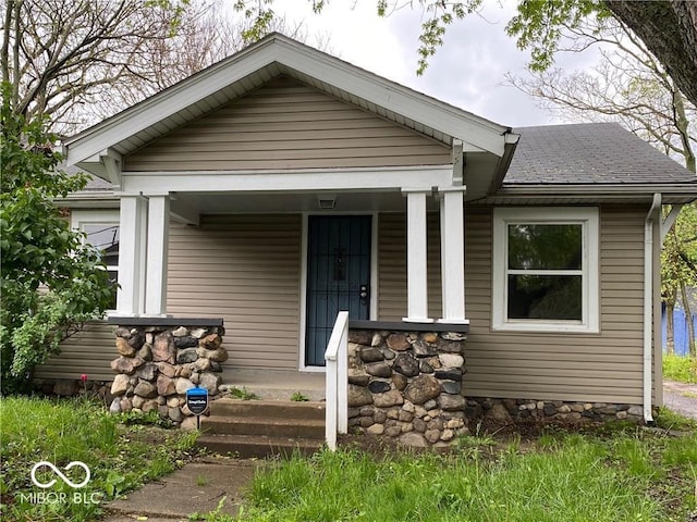 2624 E 17th St, Indianapolis, IN 46218 - view of front facade featuring covered porch and a shingled roof