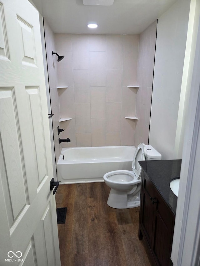 4115 Tansel Rd, Indianapolis, IN 46234 - bathroom featuring vanity, wood finished floors, toilet, and shower / bathtub combination