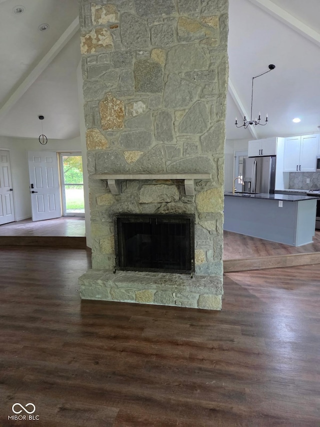 4115 Tansel Rd, Indianapolis, IN 46234 - unfurnished living room featuring high vaulted ceiling, a stone fireplace, wood finished floors, and beam ceiling