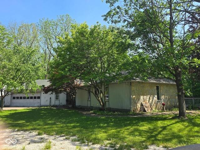 4115 Tansel Rd, Indianapolis, IN 46234 - view of front of property featuring stone siding, a front yard, driveway, and an attached garage