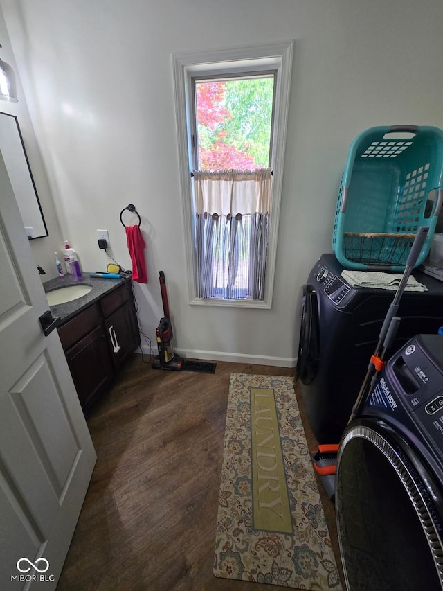 4115 Tansel Rd, Indianapolis, IN 46234 - washroom with washer and clothes dryer, wood finished floors, baseboards, and cabinet space
