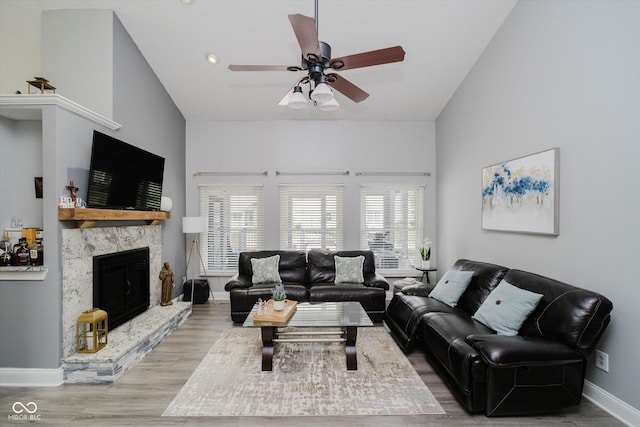7838 Chesapeake Dr E, Indianapolis, IN 46236 - living room featuring a ceiling fan, wood finished floors, baseboards, and a fireplace with raised hearth