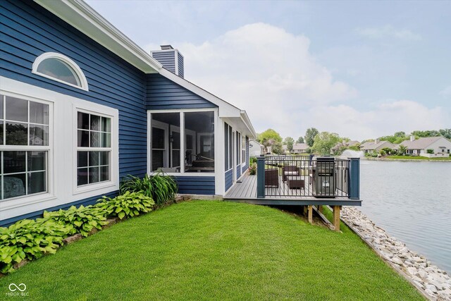 7838 Chesapeake Dr E, Indianapolis, IN 46236 - view of grassy yard with a sunroom and a deck with water view