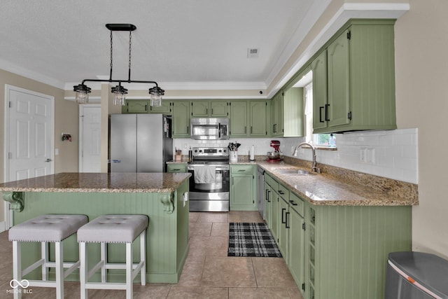 2829 Beachwalk Ln, Kokomo, IN 46902 - kitchen featuring green cabinets, stainless steel appliances, a sink, ornamental molding, and backsplash