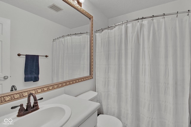 2829 Beachwalk Ln, Kokomo, IN 46902 - bathroom with toilet, vanity, a textured ceiling, and a shower with curtain