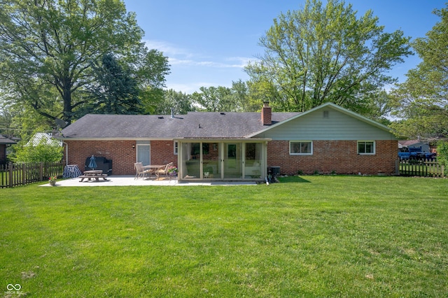 9104 W Lone Beech Dr, Muncie, IN 47304 - rear view of property with a patio, brick siding, and a chimney