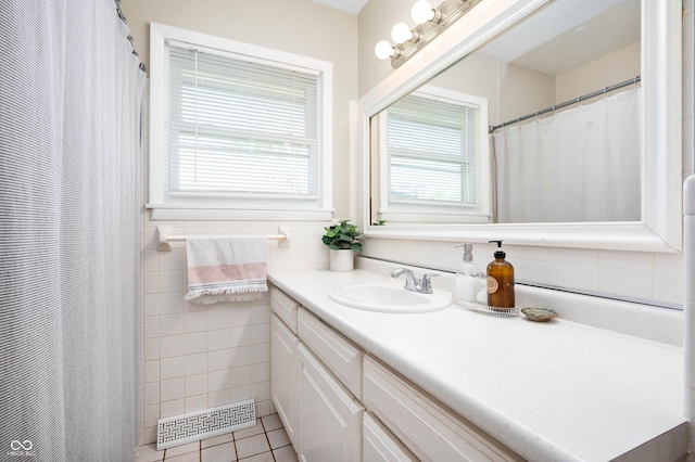 9104 W Lone Beech Dr, Muncie, IN 47304 - full bath featuring tile patterned floors, plenty of natural light, vanity, and tile walls
