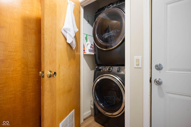 9104 W Lone Beech Dr, Muncie, IN 47304 - washroom featuring stacked washer / dryer and wood finished floors