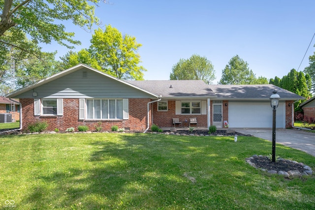 9104 W Lone Beech Dr, Muncie, IN 47304 - ranch-style house with an attached garage, brick siding, driveway, and a front lawn