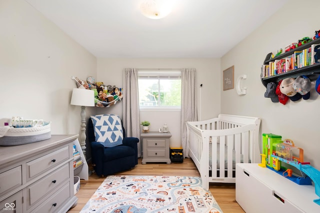 9104 W Lone Beech Dr, Muncie, IN 47304 - bedroom featuring light wood-style flooring and a nursery area