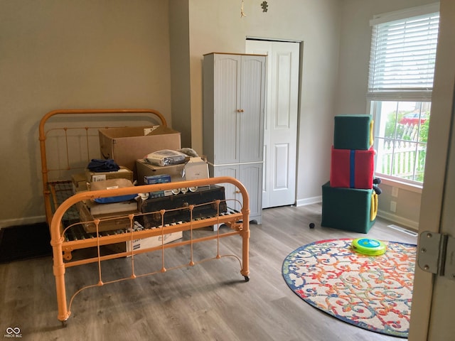 1114 N Olney St, Indianapolis, IN 46201 - bedroom featuring baseboards and wood finished floors
