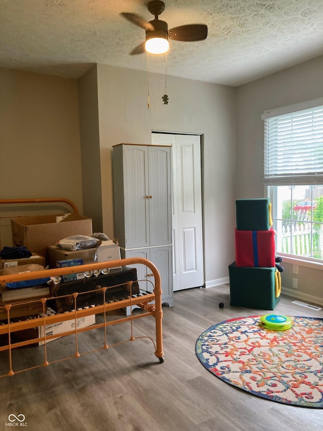 1114 N Olney St, Indianapolis, IN 46201 - dining room featuring a textured ceiling, ceiling fan, wood finished floors, and baseboards