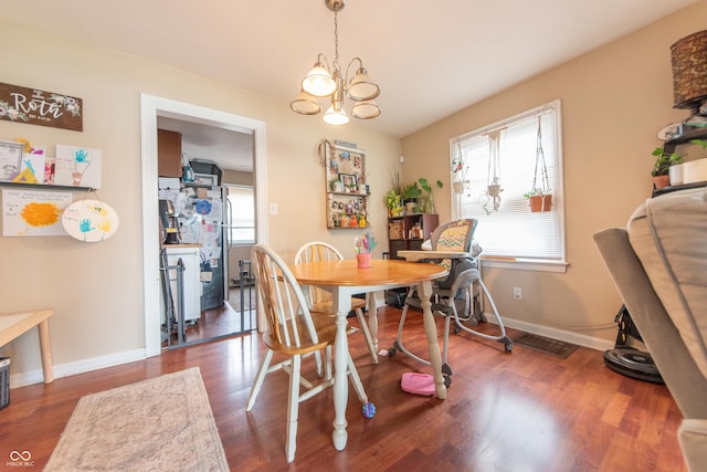 1913 Pennsylvania St, Columbus, IN 47201 - dining space with wood finished floors, a chandelier, and baseboards