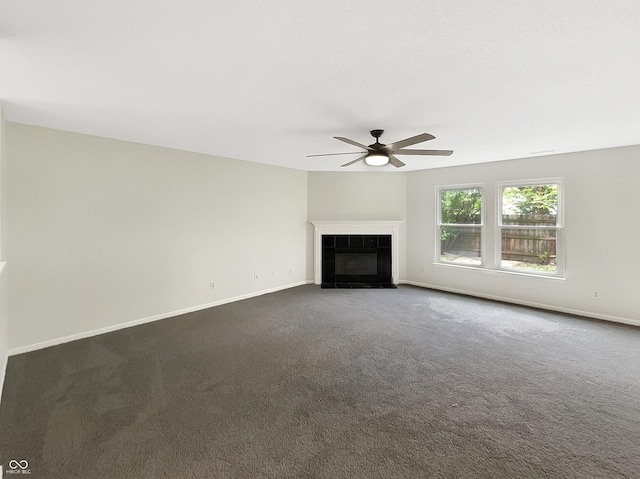 2116 Orchid Bloom Dr, Indianapolis, IN 46231 - unfurnished living room with ceiling fan, dark colored carpet, a tiled fireplace, and baseboards