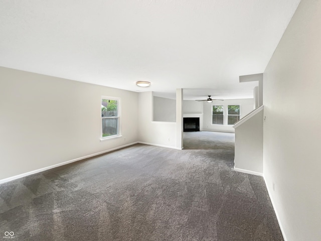 2116 Orchid Bloom Dr, Indianapolis, IN 46231 - unfurnished living room with carpet floors, healthy amount of natural light, baseboards, and a fireplace