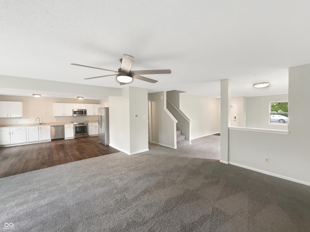 2116 Orchid Bloom Dr, Indianapolis, IN 46231 - unfurnished living room with dark carpet, baseboards, a sink, and a ceiling fan