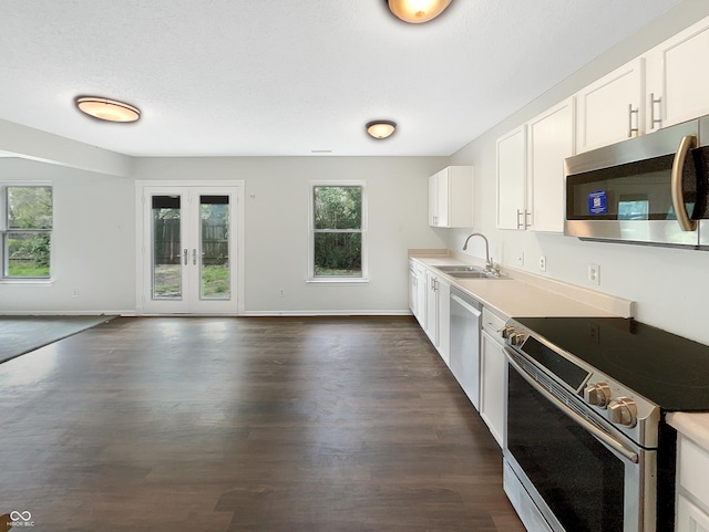 2116 Orchid Bloom Dr, Indianapolis, IN 46231 - kitchen with appliances with stainless steel finishes, a sink, dark wood-style flooring, open floor plan, and white cabinets