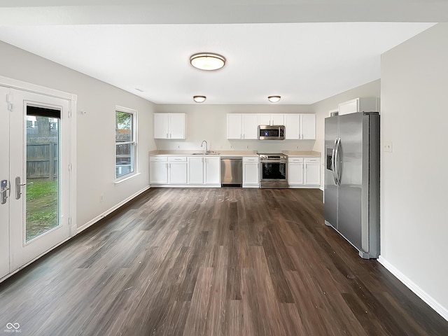 2116 Orchid Bloom Dr, Indianapolis, IN 46231 - kitchen featuring appliances with stainless steel finishes, a sink, light countertops, dark wood-style flooring, and white cabinets