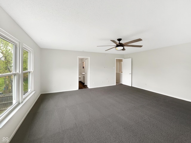 2116 Orchid Bloom Dr, Indianapolis, IN 46231 - spare room featuring baseboards, a ceiling fan, and dark carpet