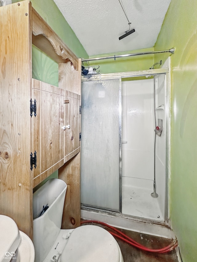 2006 N Olney St, Indianapolis, IN 46218 - bathroom with toilet, a shower stall, and a textured ceiling